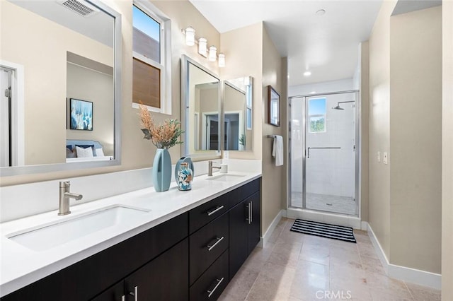 bathroom featuring tile patterned floors, vanity, and a shower with door