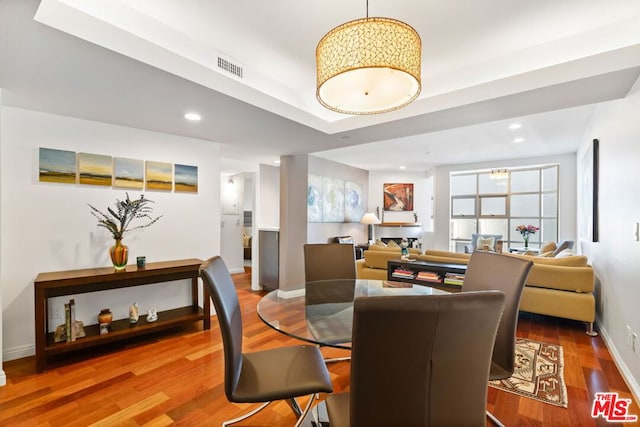 dining space with hardwood / wood-style floors