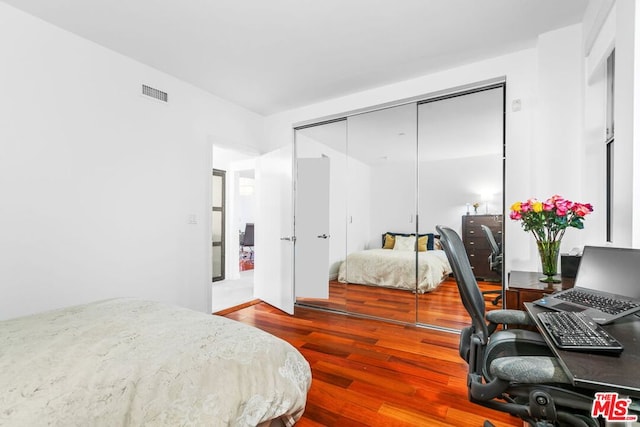 bedroom featuring a closet and wood-type flooring