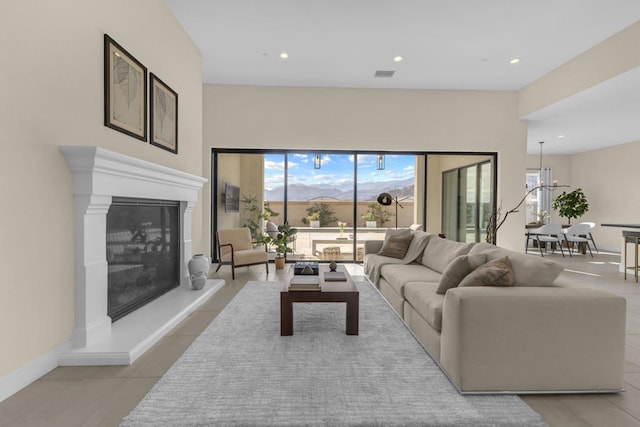 living room with a chandelier and light tile patterned flooring