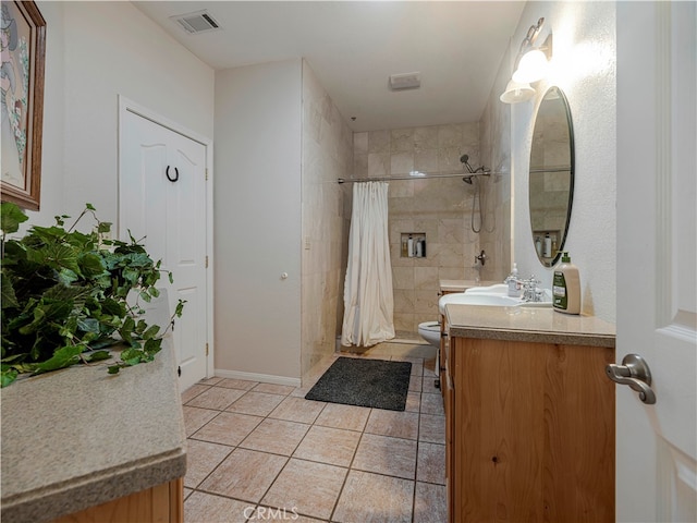 bathroom featuring vanity, toilet, tile patterned floors, and a shower with shower curtain