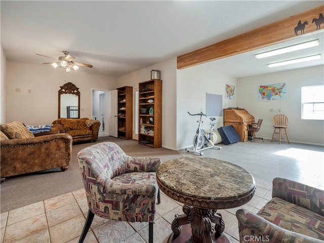 tiled living room with ceiling fan and beam ceiling