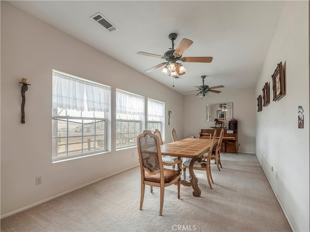 carpeted dining space featuring ceiling fan