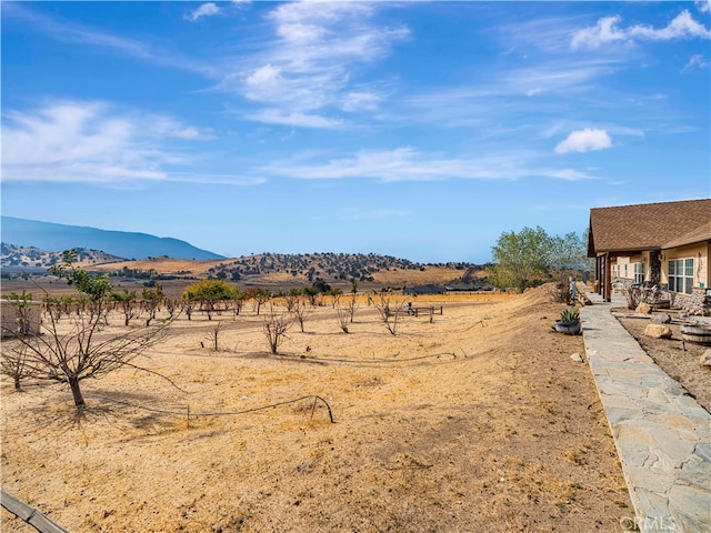 view of yard featuring a rural view and a mountain view