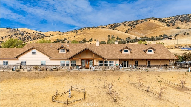 rear view of house featuring a mountain view