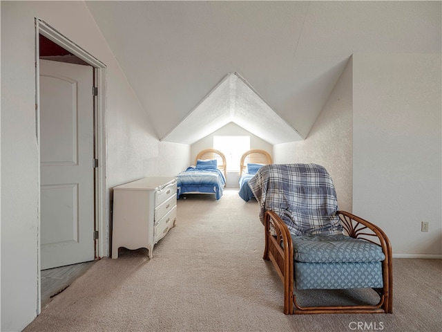 carpeted bedroom featuring vaulted ceiling