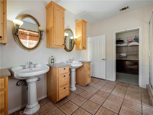 bathroom with tile patterned floors and dual sinks