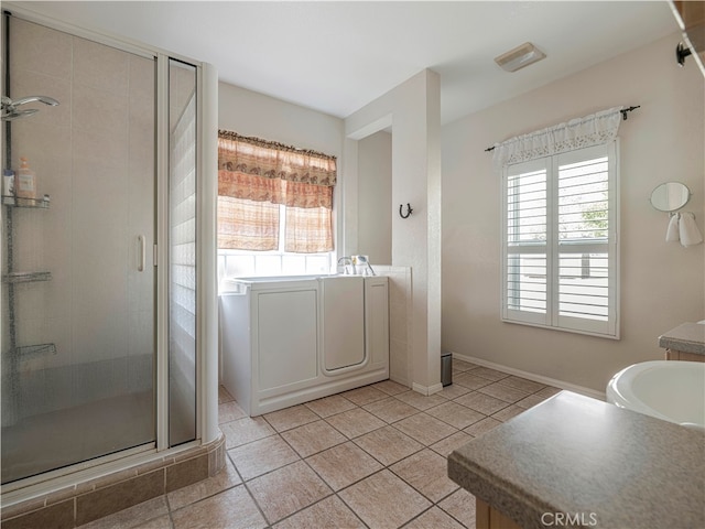 bathroom with tile patterned flooring and separate shower and tub