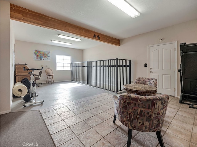 interior space featuring beam ceiling and light tile patterned floors