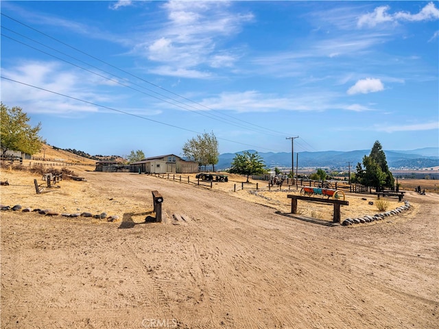 view of yard featuring a mountain view and a rural view