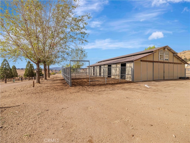 view of stable with a rural view