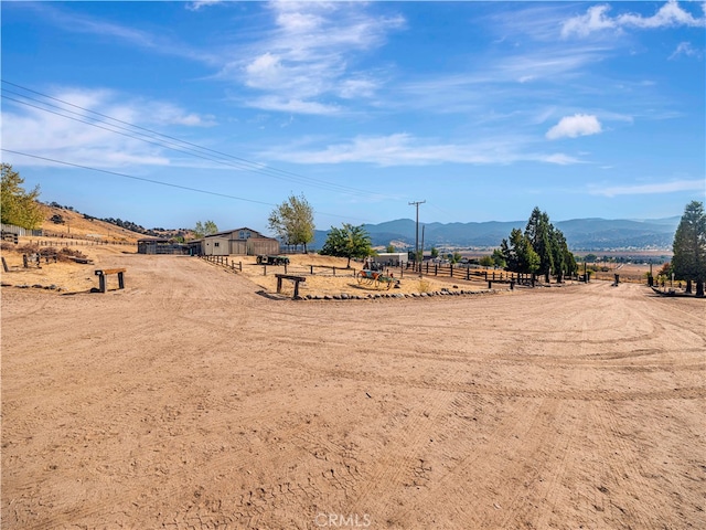 view of yard with a mountain view and a rural view