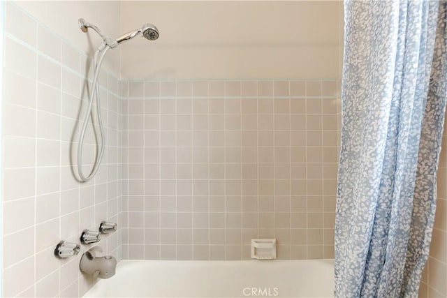 bathroom with shower / bathtub combination with curtain