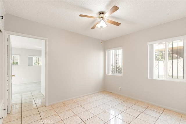 spare room with ceiling fan and a textured ceiling