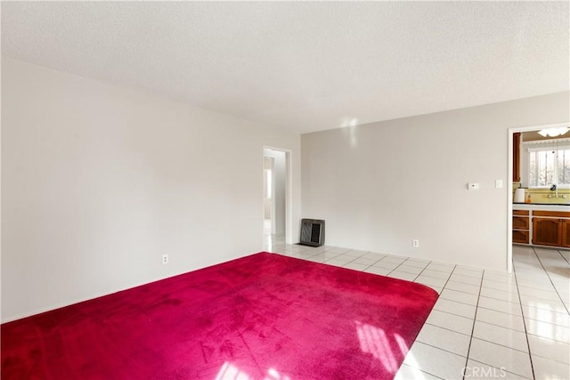 unfurnished living room featuring light tile patterned floors and a textured ceiling