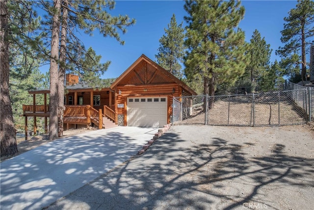 log home featuring a garage and a deck