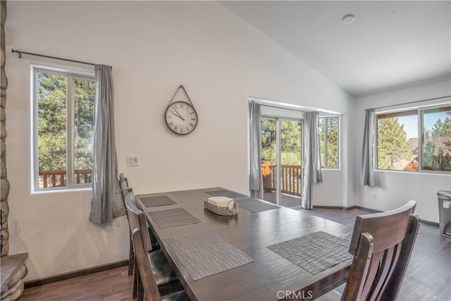 dining area with lofted ceiling, plenty of natural light, and dark hardwood / wood-style flooring