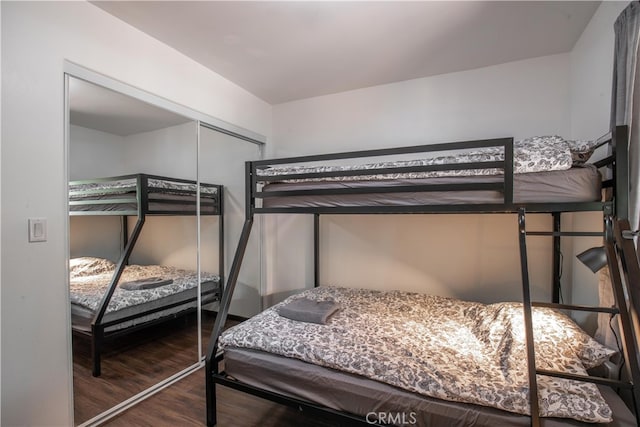 bedroom featuring a closet and dark hardwood / wood-style flooring