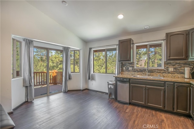 kitchen featuring a wealth of natural light, sink, dark hardwood / wood-style flooring, and tasteful backsplash