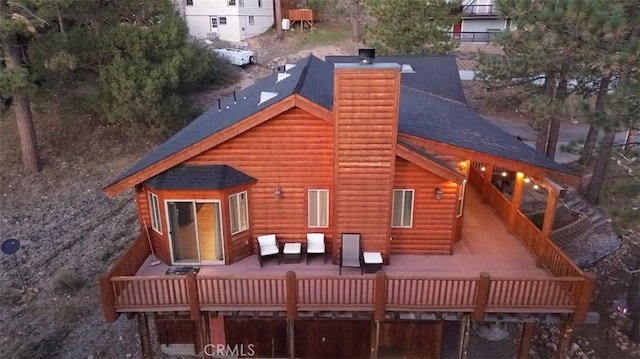 rear view of house featuring a deck