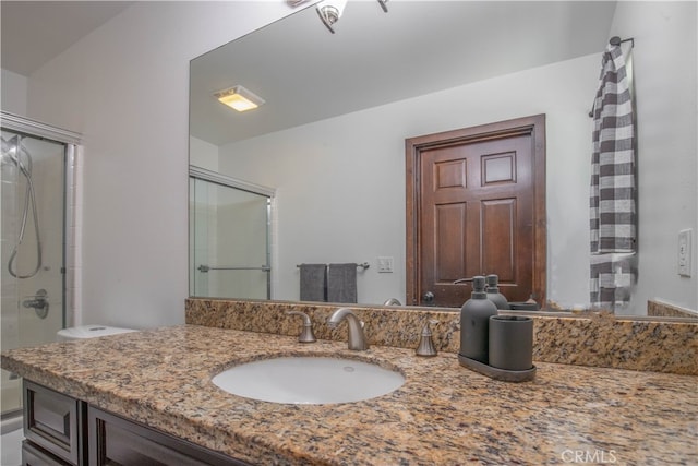 bathroom with vanity, lofted ceiling, and an enclosed shower