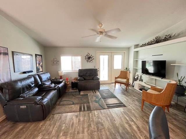 living room with lofted ceiling, hardwood / wood-style flooring, and ceiling fan