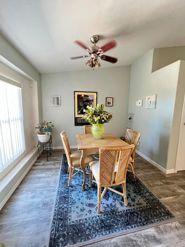 dining space featuring dark wood-type flooring, ceiling fan, a textured ceiling, and lofted ceiling