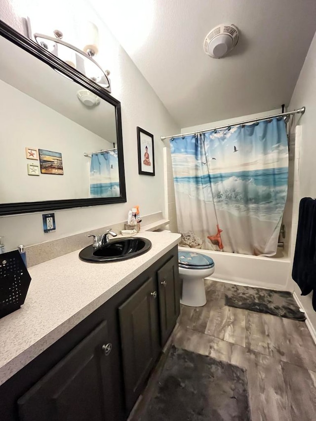 full bathroom featuring wood-type flooring, vaulted ceiling, toilet, shower / bath combo, and vanity