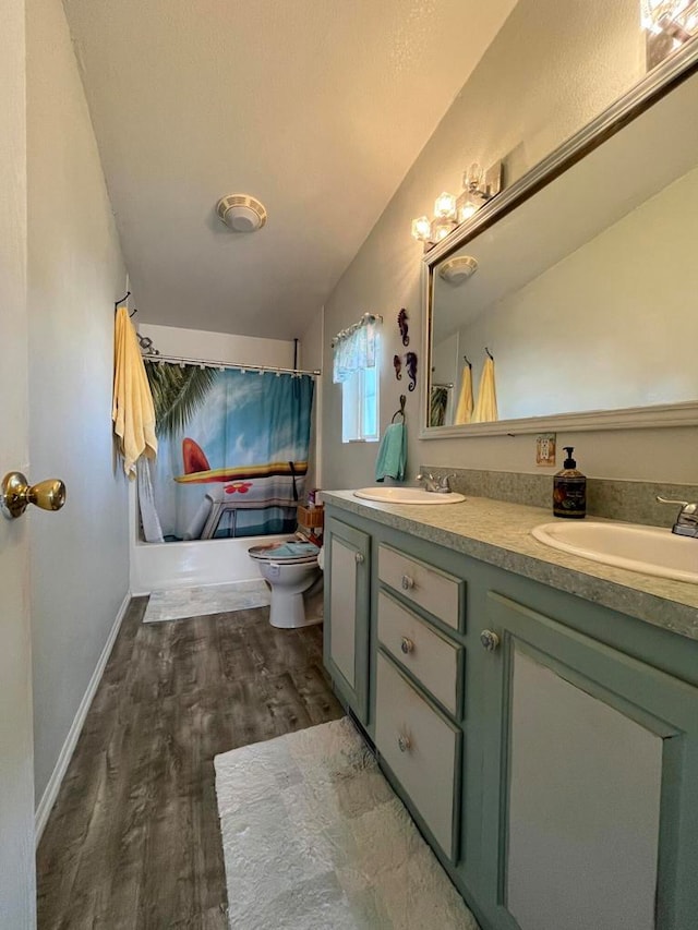 bathroom featuring vanity, hardwood / wood-style floors, toilet, and walk in shower