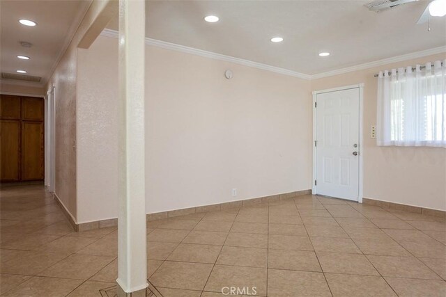 tiled entryway featuring ornamental molding and ceiling fan