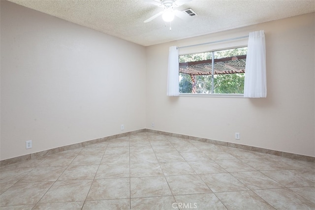 unfurnished room featuring a textured ceiling, light tile patterned floors, and ceiling fan