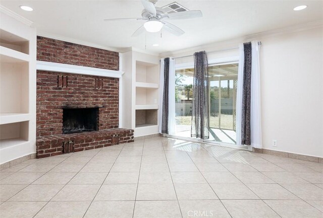 unfurnished living room with a fireplace, ceiling fan, crown molding, light tile patterned floors, and built in shelves