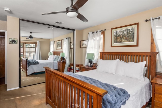 carpeted bedroom featuring a closet and ceiling fan