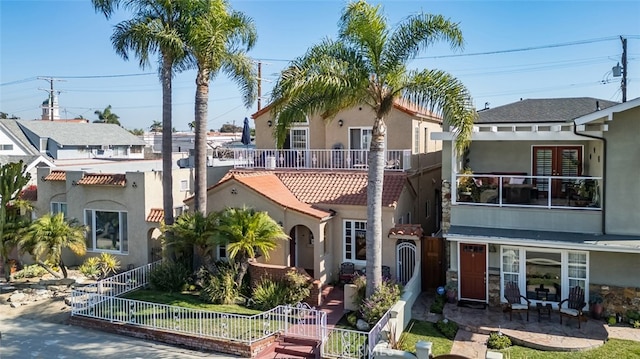 view of front of house with a patio and a balcony