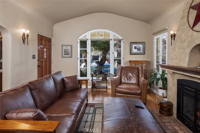 living room with wood-type flooring and vaulted ceiling