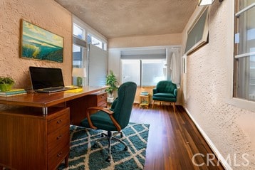 office space with dark hardwood / wood-style flooring