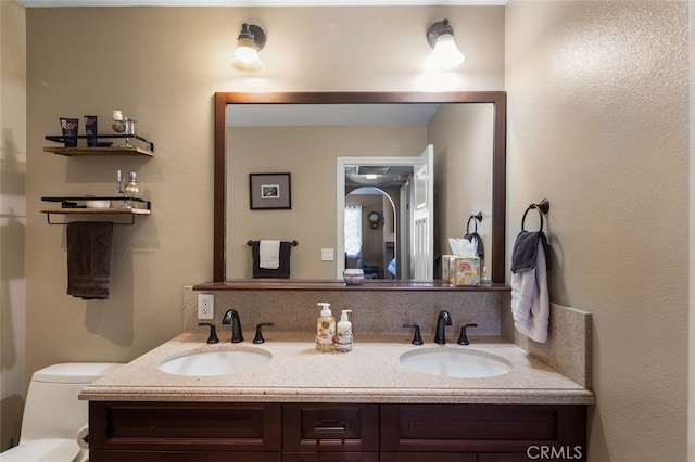 bathroom with toilet and vanity