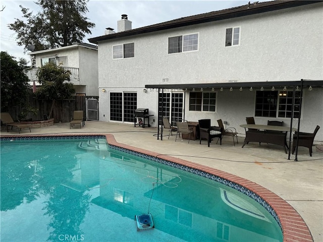 view of pool with a patio area and grilling area