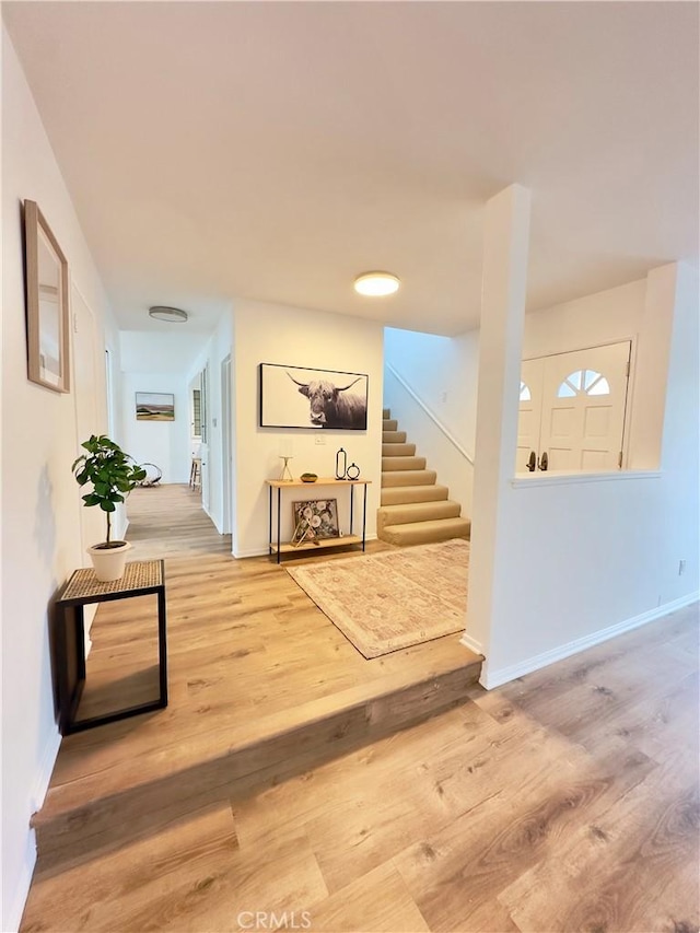 hallway with hardwood / wood-style flooring