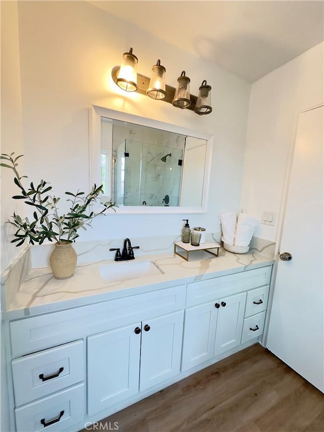 bathroom featuring vanity, hardwood / wood-style flooring, and an enclosed shower