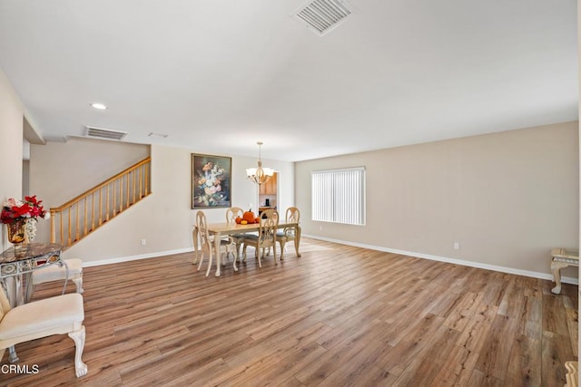 dining area featuring a notable chandelier and light hardwood / wood-style floors