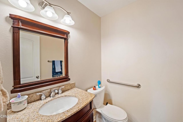 bathroom with toilet and vanity