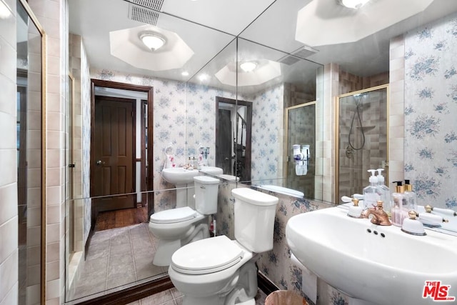 bathroom featuring toilet, sink, a shower with door, and hardwood / wood-style flooring