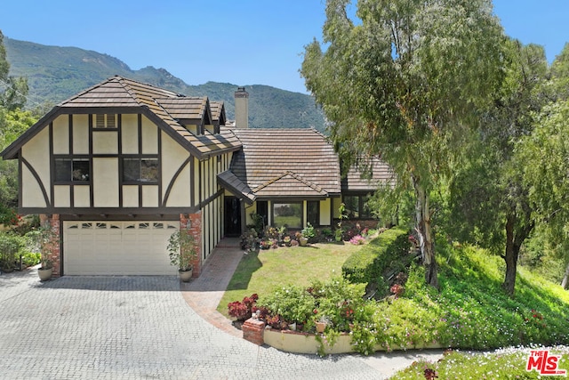 tudor-style house featuring a mountain view and a garage