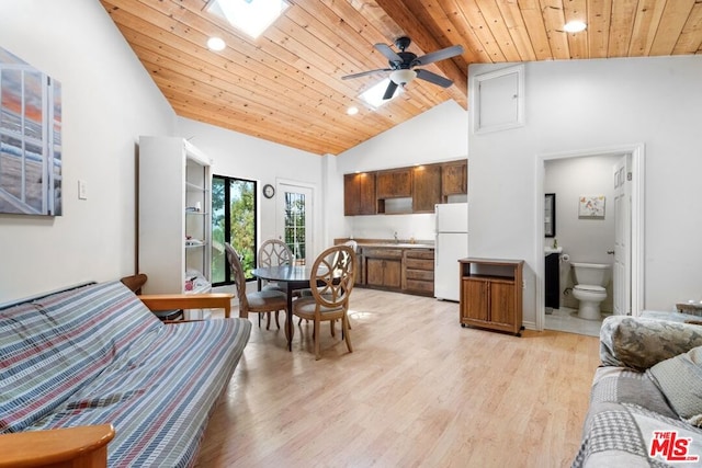 living room featuring wooden ceiling, high vaulted ceiling, light hardwood / wood-style flooring, a skylight, and ceiling fan