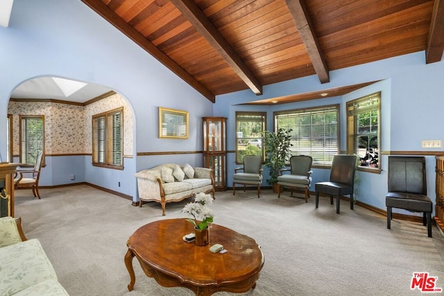 carpeted living room featuring lofted ceiling with beams and wood ceiling