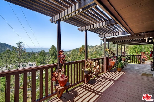 deck with a mountain view and a pergola