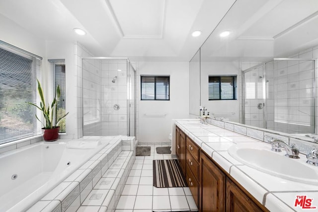 bathroom with plus walk in shower, tile patterned flooring, and vanity