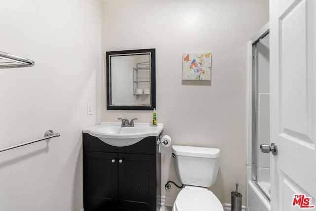 full bathroom featuring shower / bath combination with glass door, vanity, and toilet