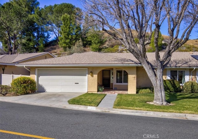 ranch-style house with a garage and a front yard